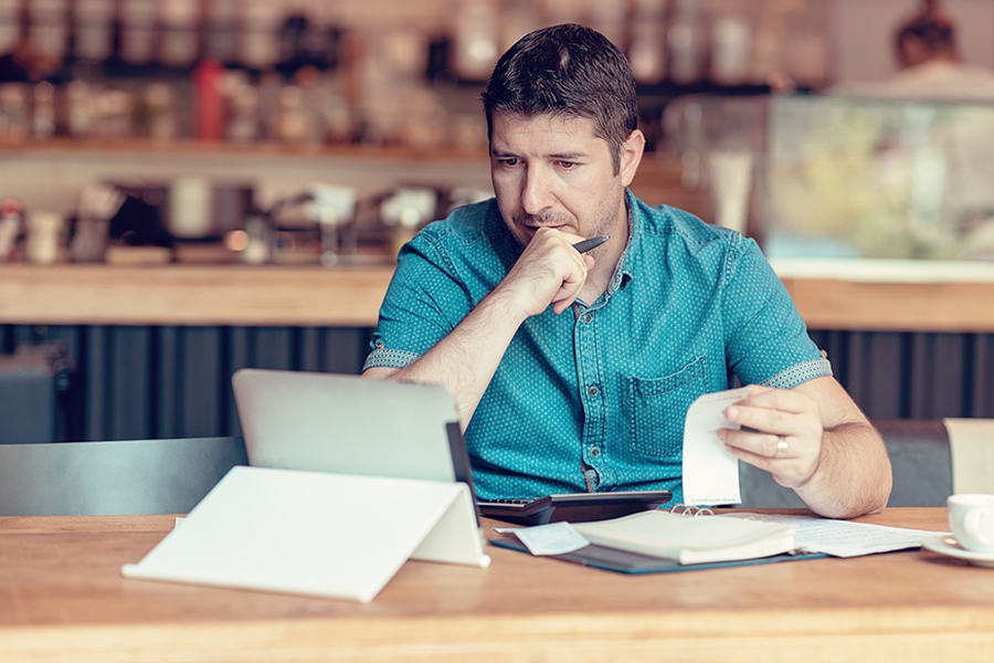 Man reviewing monthly financial statements