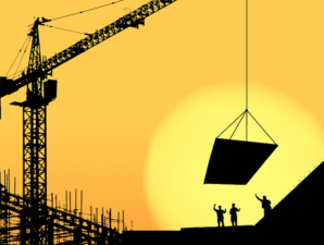 Construction workers on site during sunset